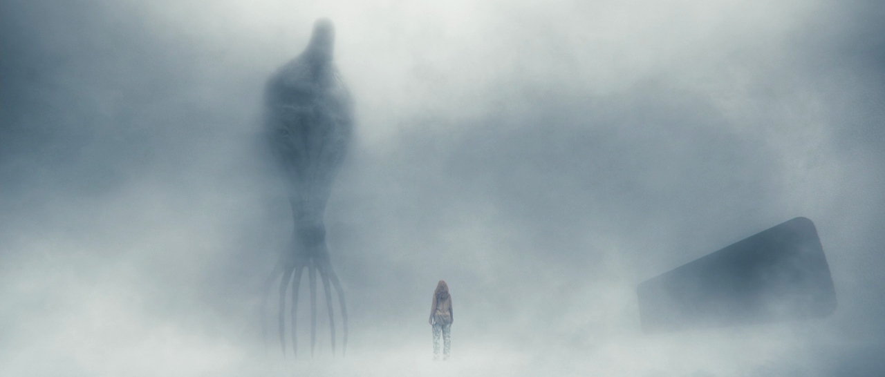 A small human figure standing in dense fog before a towering seven-limbed alien, with a dark rectangular doorway to the right.
